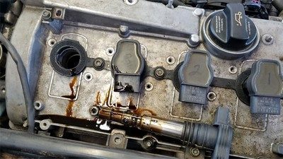 oil in spark plug well