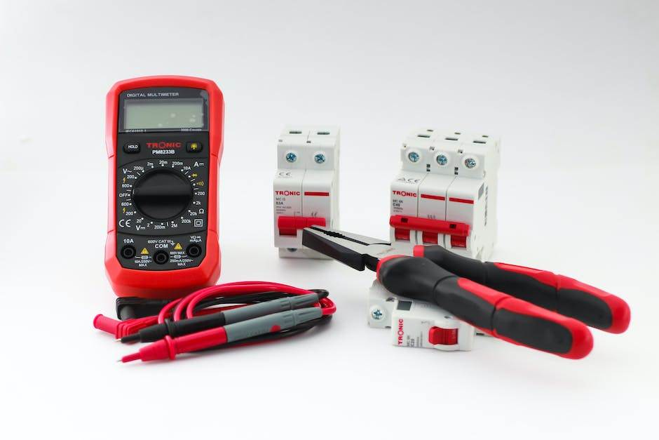 Image of different electrical diagnostic tools, such as a multimeter, electrical network analyzer, and oscilloscope, laid out on a table.