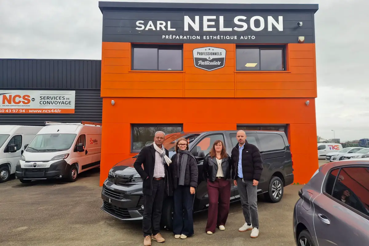 Two logistics specialists discussing an electric vehicle