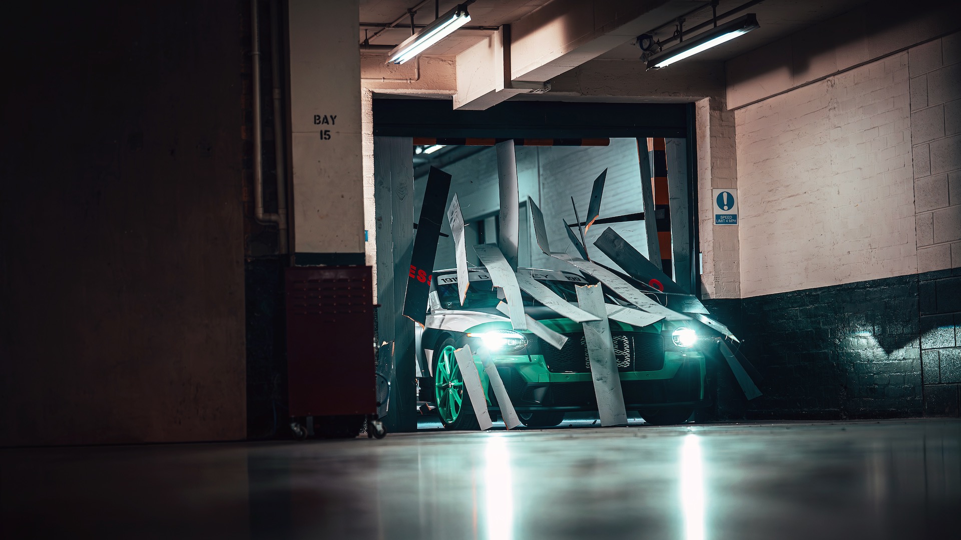 Bentley Supersports busting through a door.